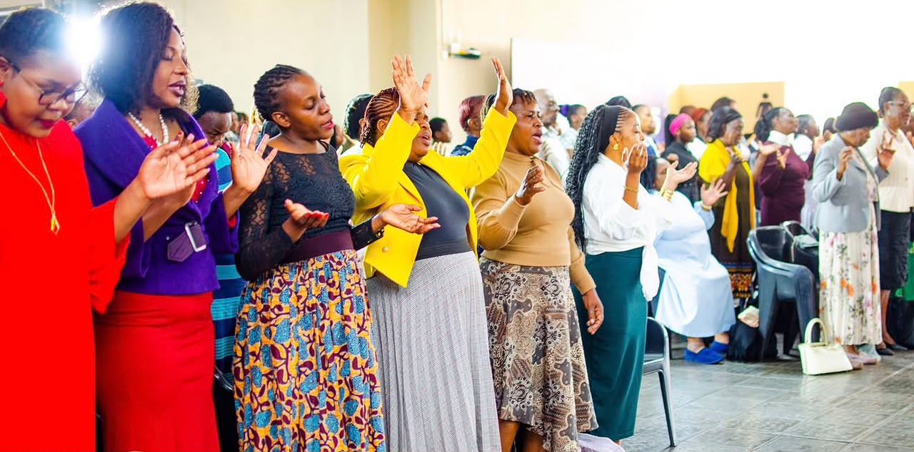 Congregation gathered in worship, hands raised